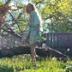 A blonde woman shits on the ground at an outdoor location while sitting on a fallen tree limb. Video quality is grainy, but poop can be seen falling from her ass at a distance. 720P vertical HD format video. About a minute.